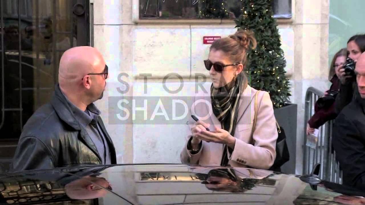 Celine Dion greets fans outside her hotel, playing a fan's Ukulele before signing it