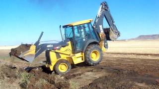 John Deere 410J back hoe filling in a culvert at the farm...