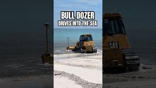Bull Dozer Drives Into The Sea