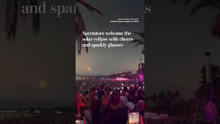 Spectators welcome the solar eclipse with cheers and sparkly glasses