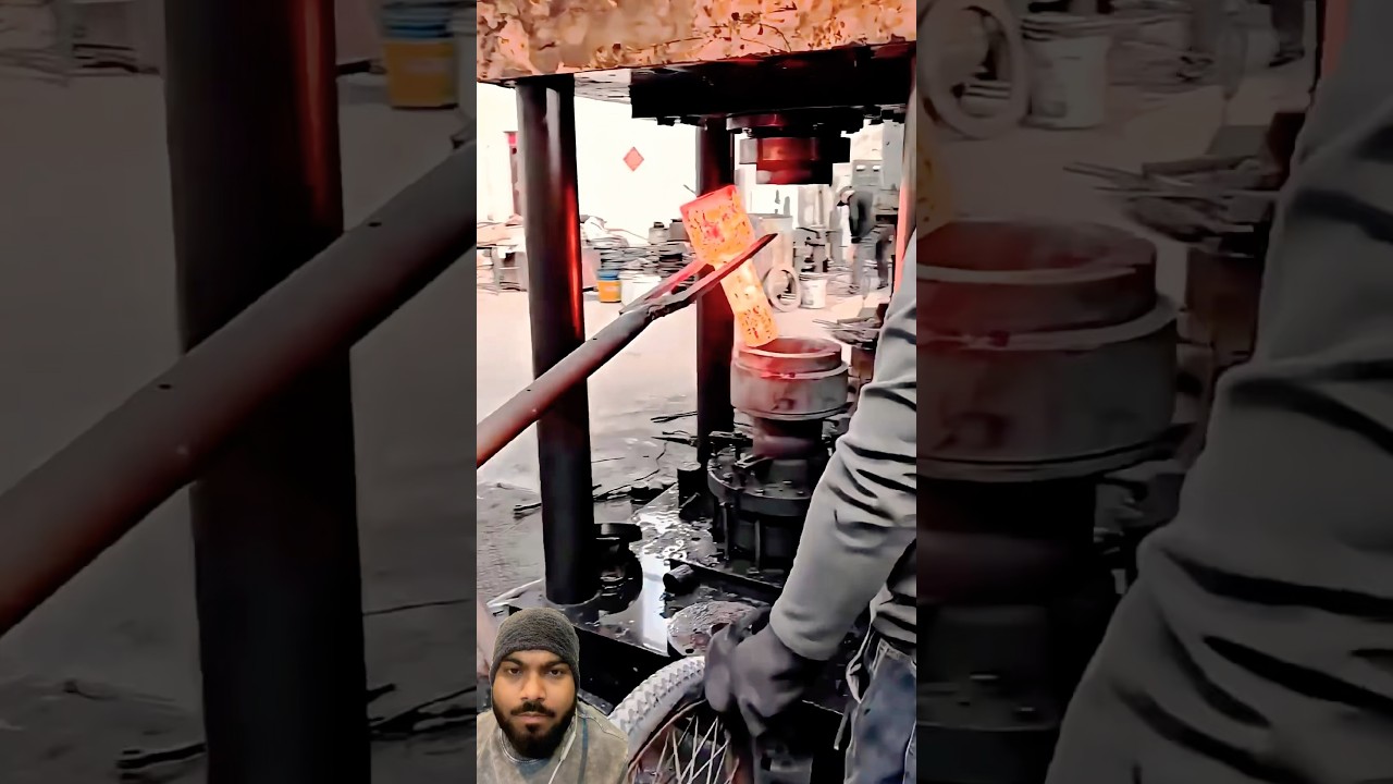 Hydraulic press on red hot metal forging 