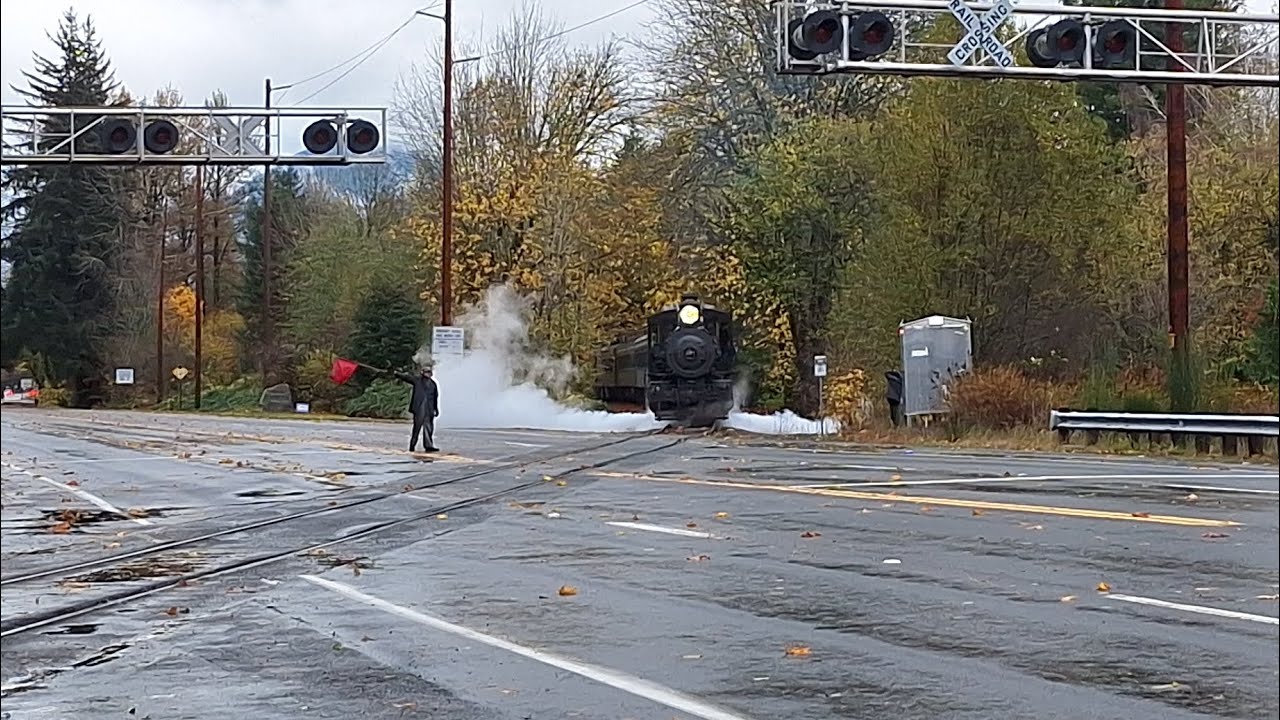 Northwest railway museum excursion train going through a malfunctioning crossing gate