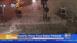 Ocean waves crashed over the sand at balboa pier in newport beach
friday night, and into parking lots streets. joy benedict reports.