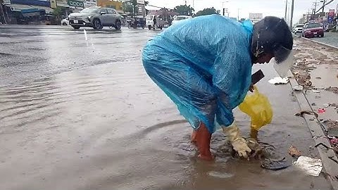 Protect Unclog Drain by Garbage and Rain Storms Full Flooding on the Street Road