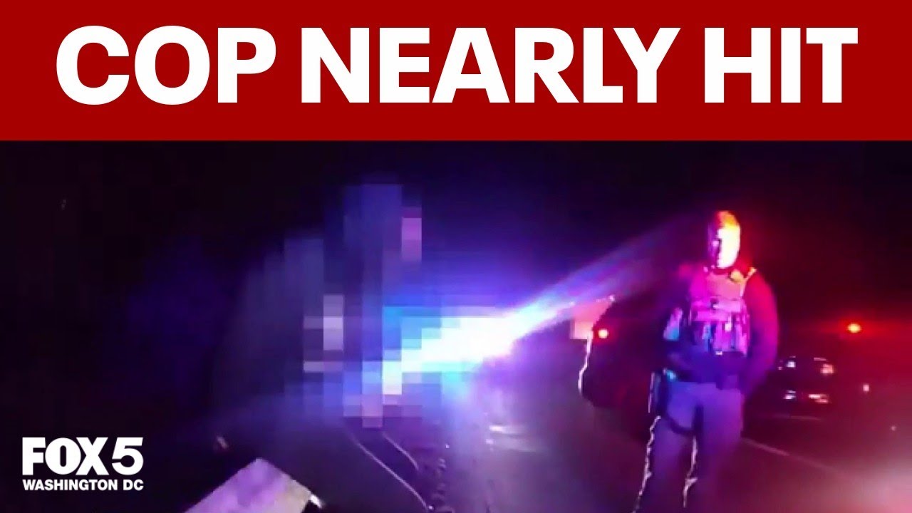 RAW VIDEO: Police officer nearly hit by car on highway
