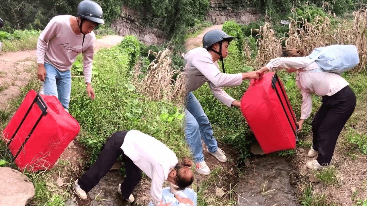 A kind young man helped a beautiful woman carry her suitcase across the river!