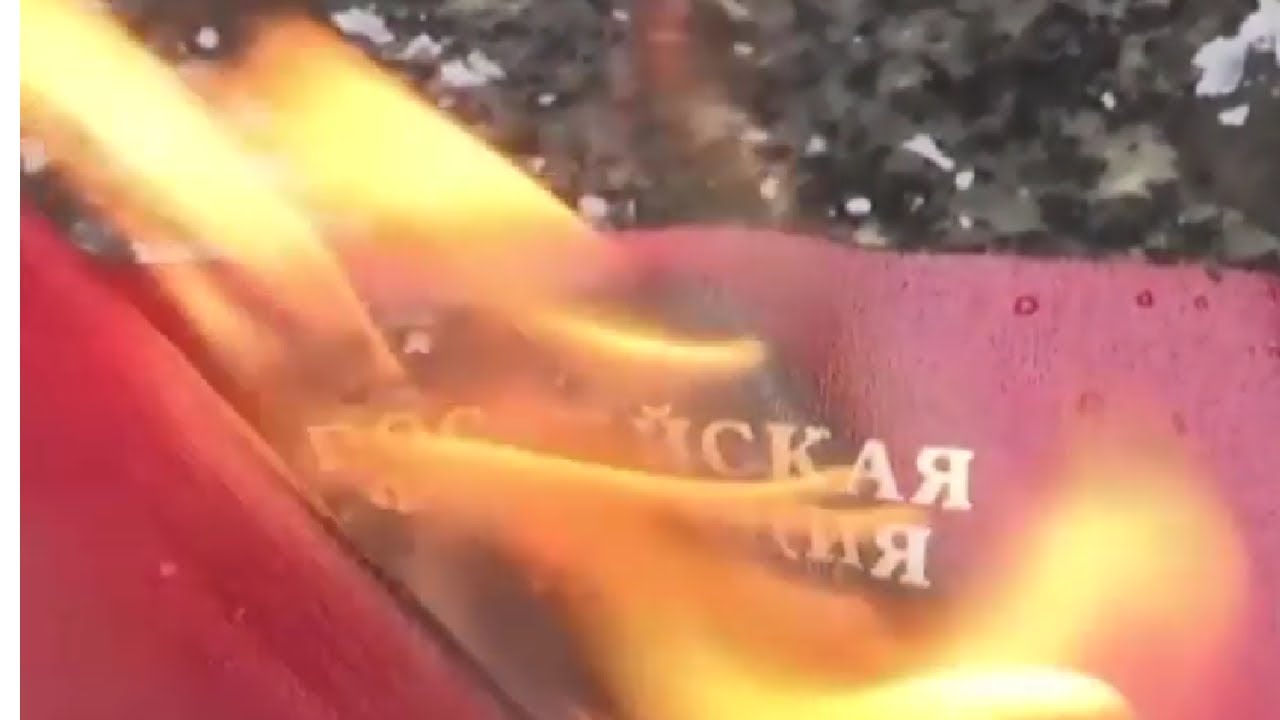 A man is seen burning his Russian passport in Serbia