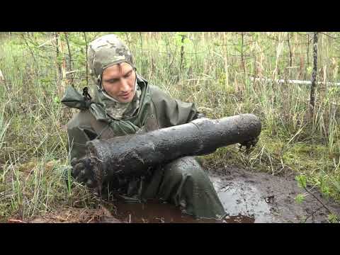 Blown-up military ammunition dump in a swamp, war excavation