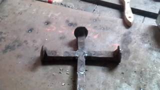 Making a railroad spike cross.