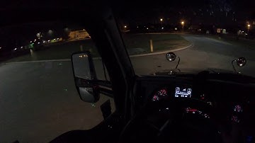 Swift truck backing up at Walmart Dock at night
