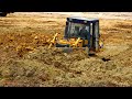 Extremely komatsu bulldozer equipment pushing deep soil group truck dumper job dirt spread