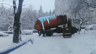 Winter garbage truck shows tricks in cold weather. Happy December for US.
