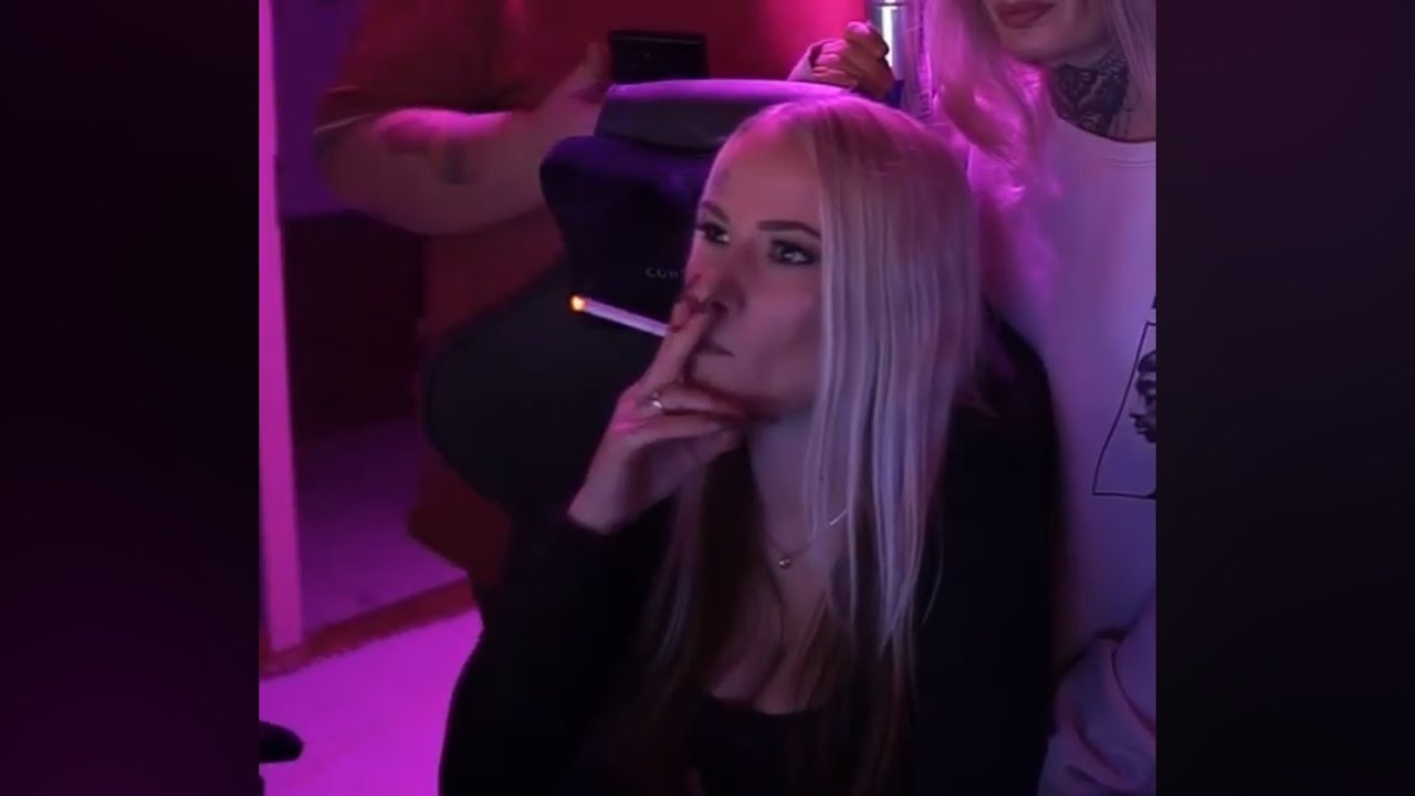 Tattooed blonde smoke cigarette