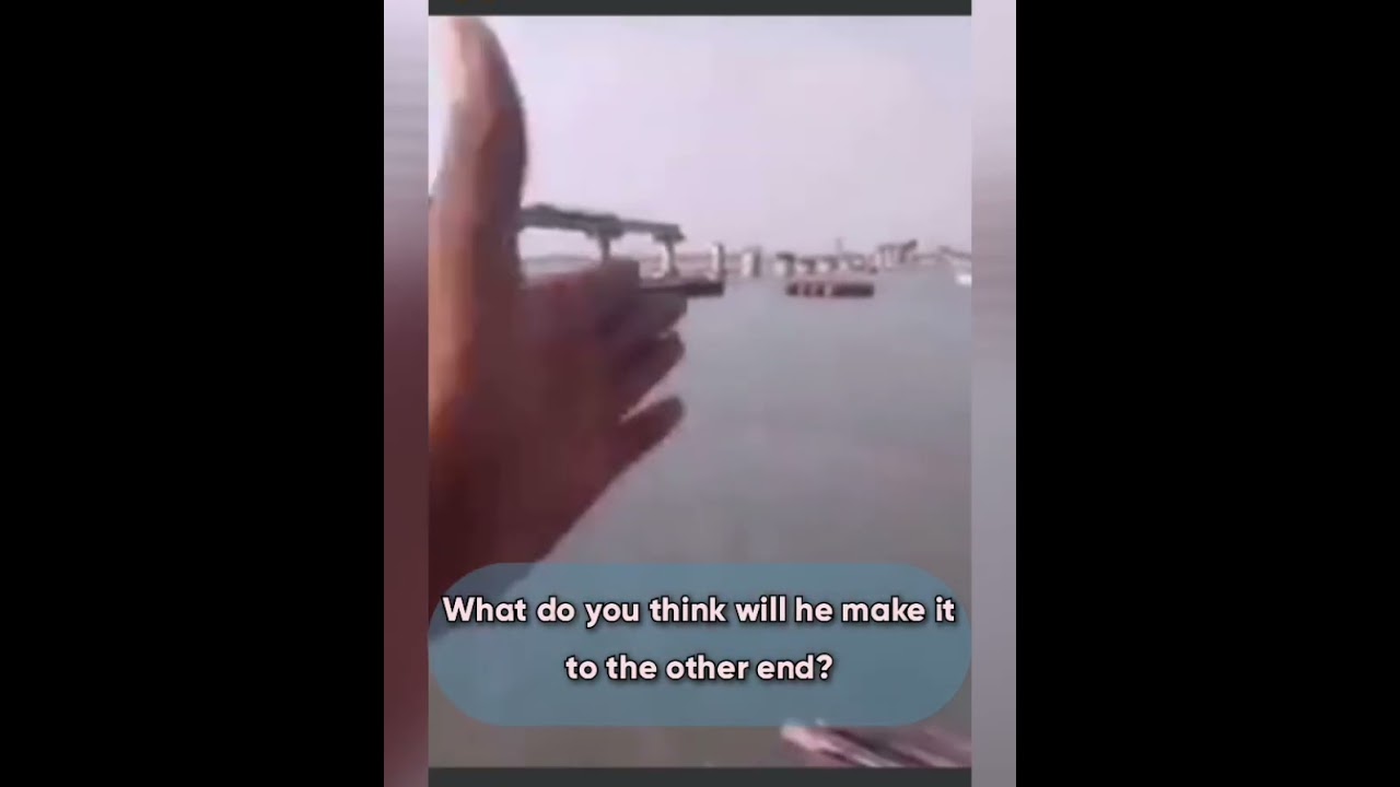 Crazy man trying to cross river on bike. 😬