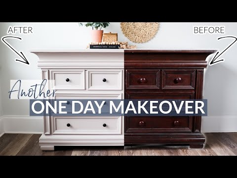 black dresser with round mirror