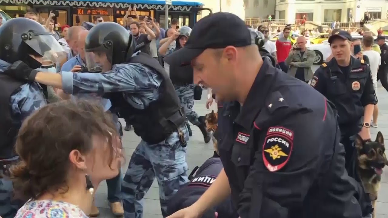 breaking free Russian protesters beaten by police