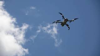 Mavic 2 Pro Drone Floating in Sky - Drone Footage Wealth