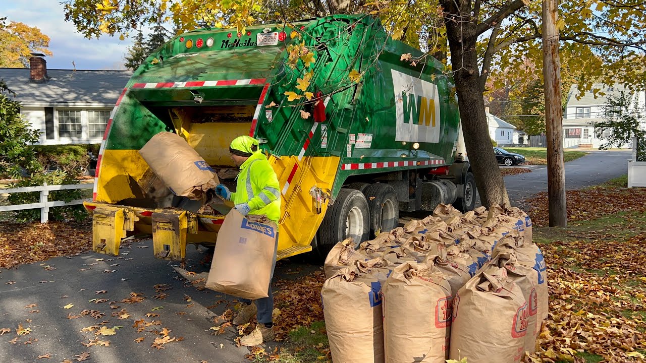 WM Garbage Truck Demolishing Peak Week Piles