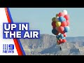 Magician flies over desert with 50 balloons | 9 News Australia