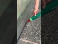 He works alone at home, adding outer sealant to the glass door so it can be maintained anytime