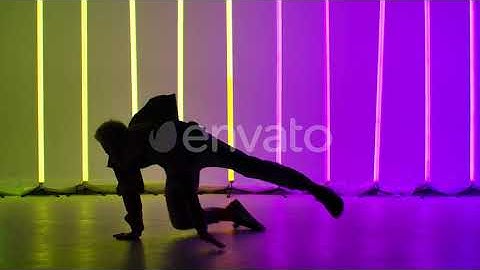 A Professional Breakdancer Performs Complex Hand Rotations. Silhouette of a Man Dancing Against ...