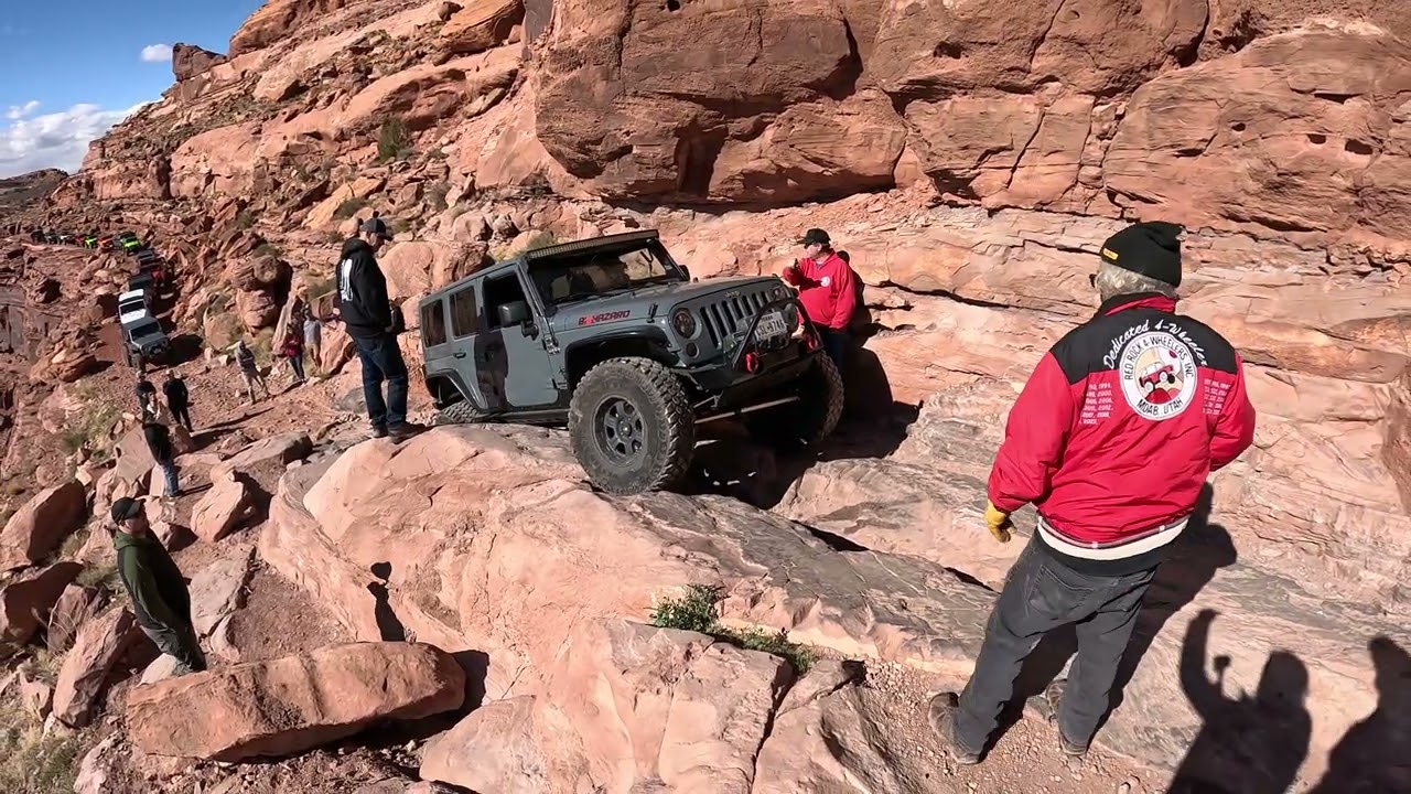 Climbing up Cliffhanger obstacle on Cliffhanger trail
