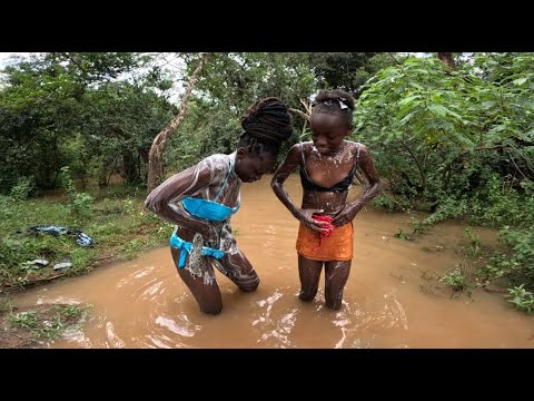 How African Girls Bath In The River In The Village