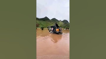 Excavator rescues people trapped in floodwaters.