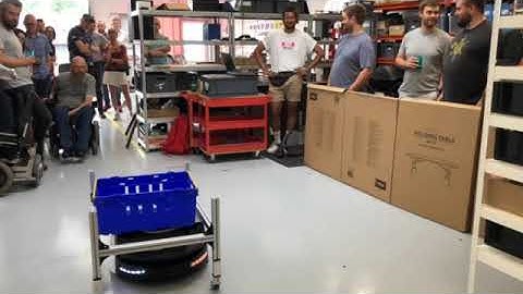 Autonomous mobile robot moving a trolley