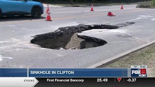 Drivers navigate around sinkhole caused by water main break in Clifton