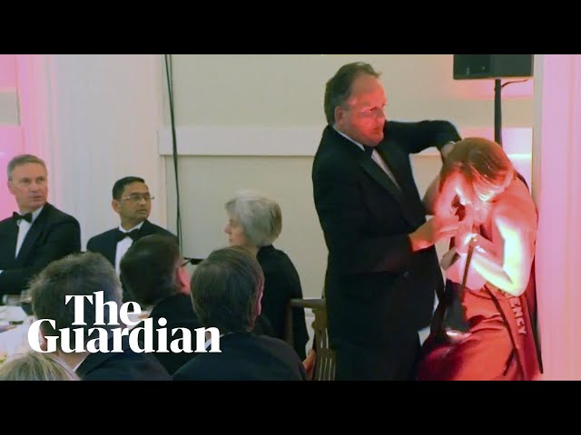 Conservative MP Mark Field grabs climate protester by the neck class=