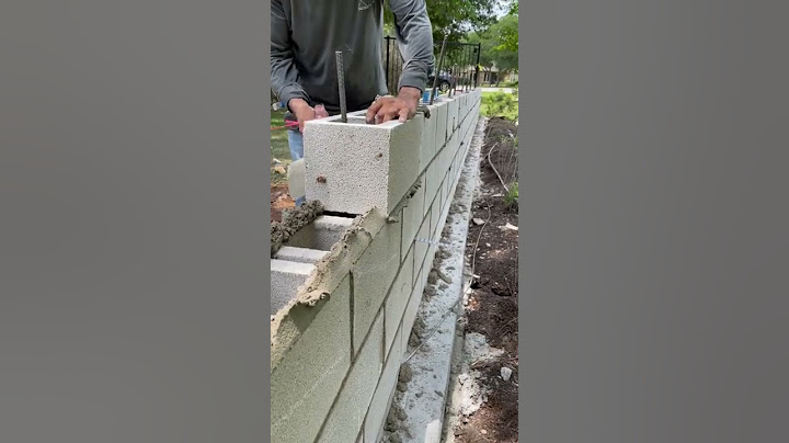 Installing some 8x8x16 CMU blocks for a decretive fence wall
