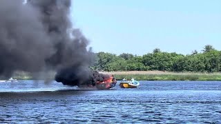 Black smoke billows from boat on Merrimack River