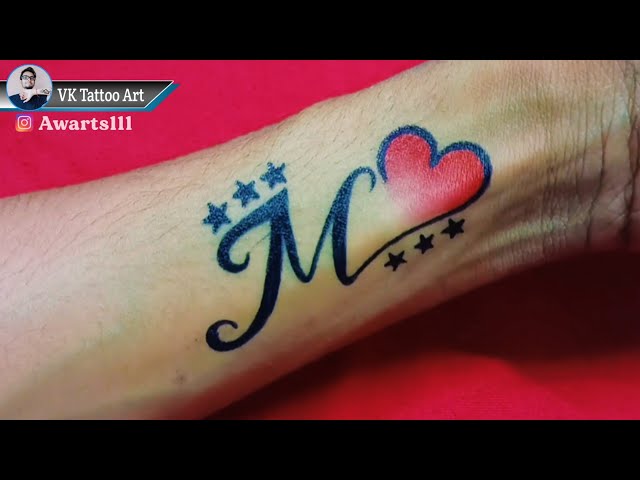 M latter With Heartbeat Tattoo | Tattoo lettering, Name tattoo on hand,  Initial tattoo