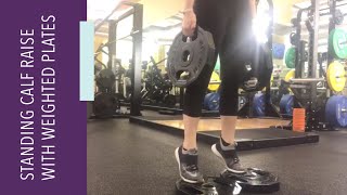 Stand tall with your feet narrower than hip-width apart, and hold a
weight plate in each hand down at sides. if possible, place the balls
of o...