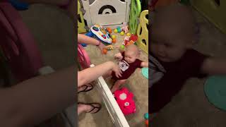 Girl falls on back after hanging from baby gate