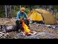 Camping in the forest with campfire and rain