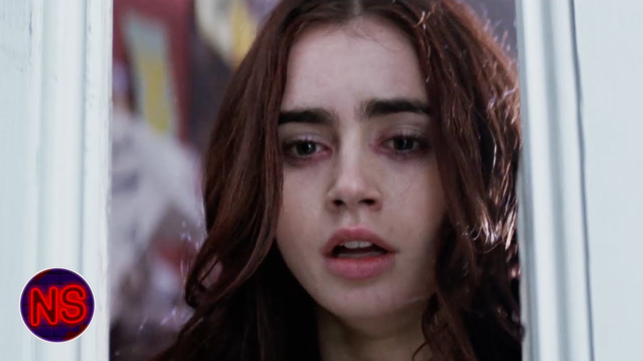Now scaring. The movie is Called City of Bones, the woman Lily Collins and the blonde man Jamie Campel Bower.