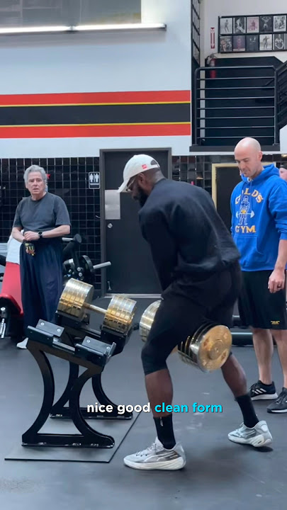 Saving the day by Moving the 330 pound Gold dumbbells at golds gym Venice