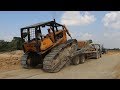 អាប៊ុលធំបរចុះ រុញដីធ្វើផ្លូវ - bulldozer unloading trailer and dozer pushing soil
