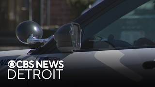 Man in custody after child found in impounded car in Metro Detroit