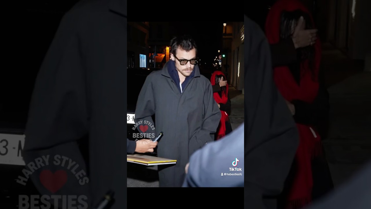 Someone attempting to get an autograph last night in Paris with Harry Styles