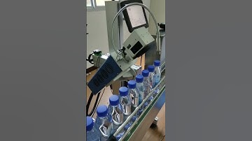 Laser marking machine coding and marking date in beverage production line soda water bottles