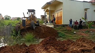 MOTOR GRADER DOES THEIR OWN FILLING OF A SMALL RIVER FOR THE ROAD