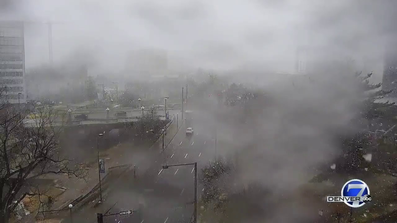 Snow falls in downtown Denver as storm moves through Colorado - YouTube