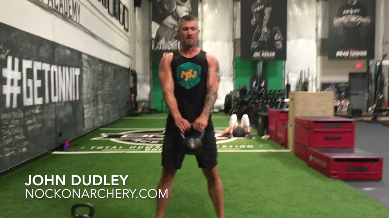 John Dudley gets coached on kettlebell exercise at Onnit Academy