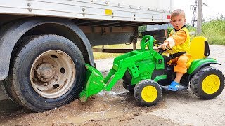 Truck stuck in the mud - Rubble ride on power wheels tractor to help