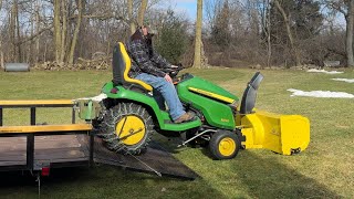 Loading a John Deere X590 with a snow blower and tire chains on a trailer