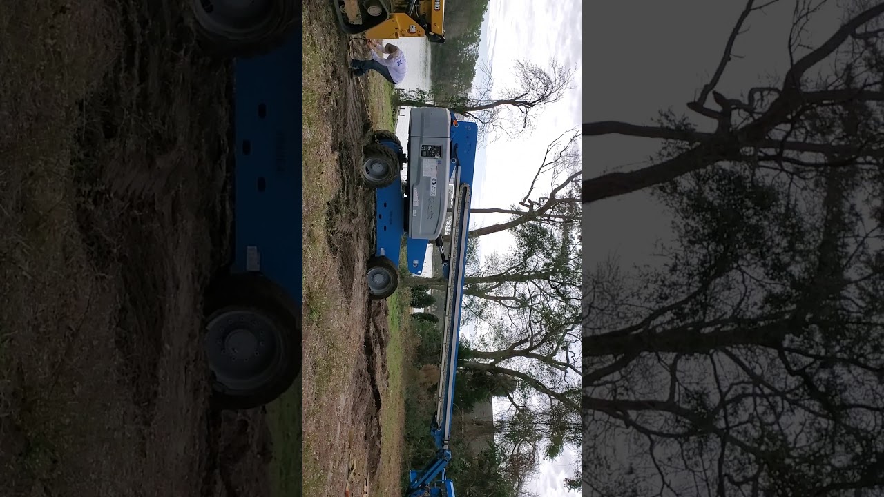 CAT skid steer pulling out a Genie lift YouTube