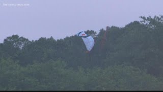 Powered paraglider crashes into tree, suspending man 80 feet in the air